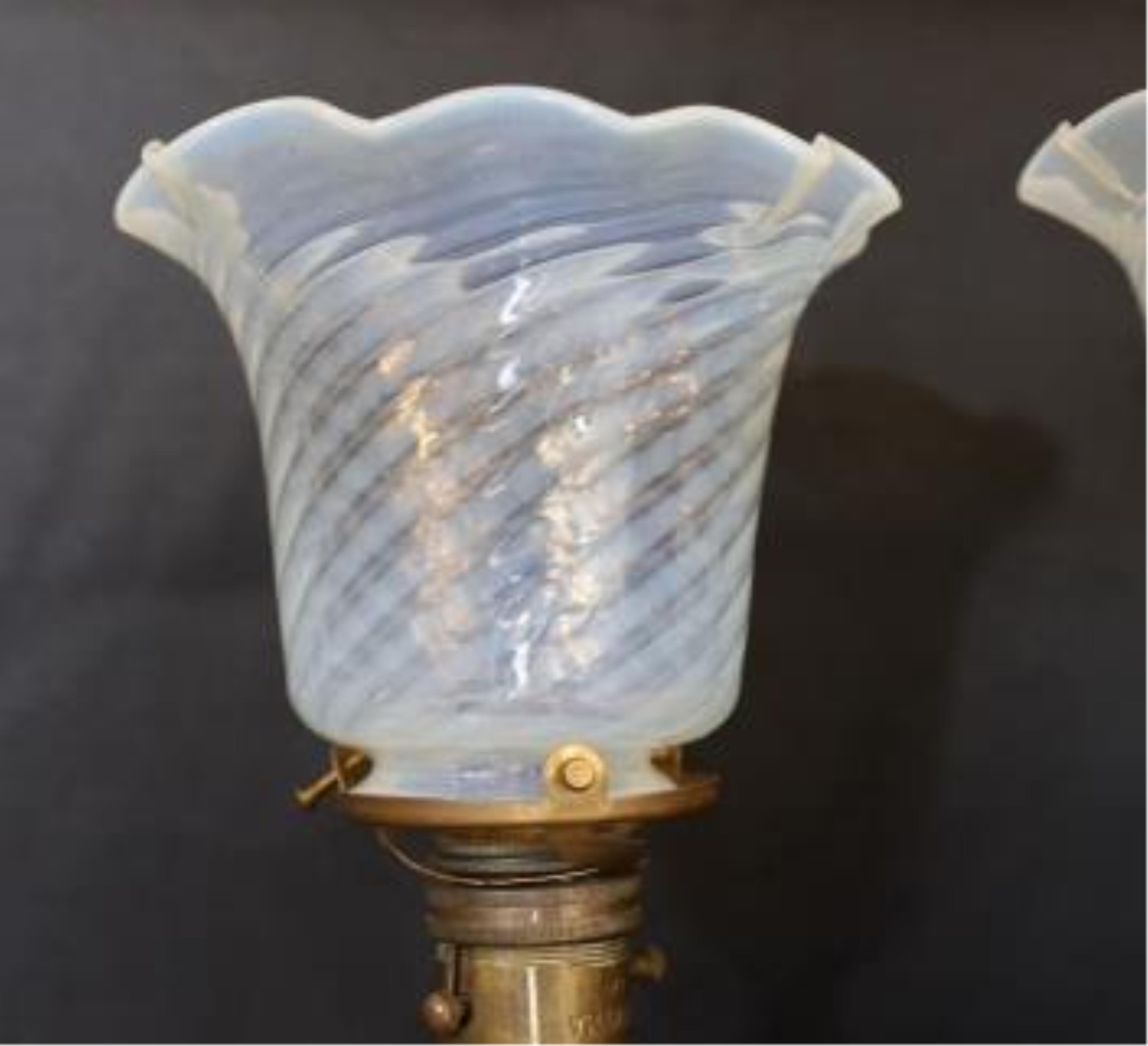 A pair of brass Pullman lamps with gimbal stems and Vaseline glass shades, modelled for wall mounting or freestanding, height to top of shade 40cm. Condition - good